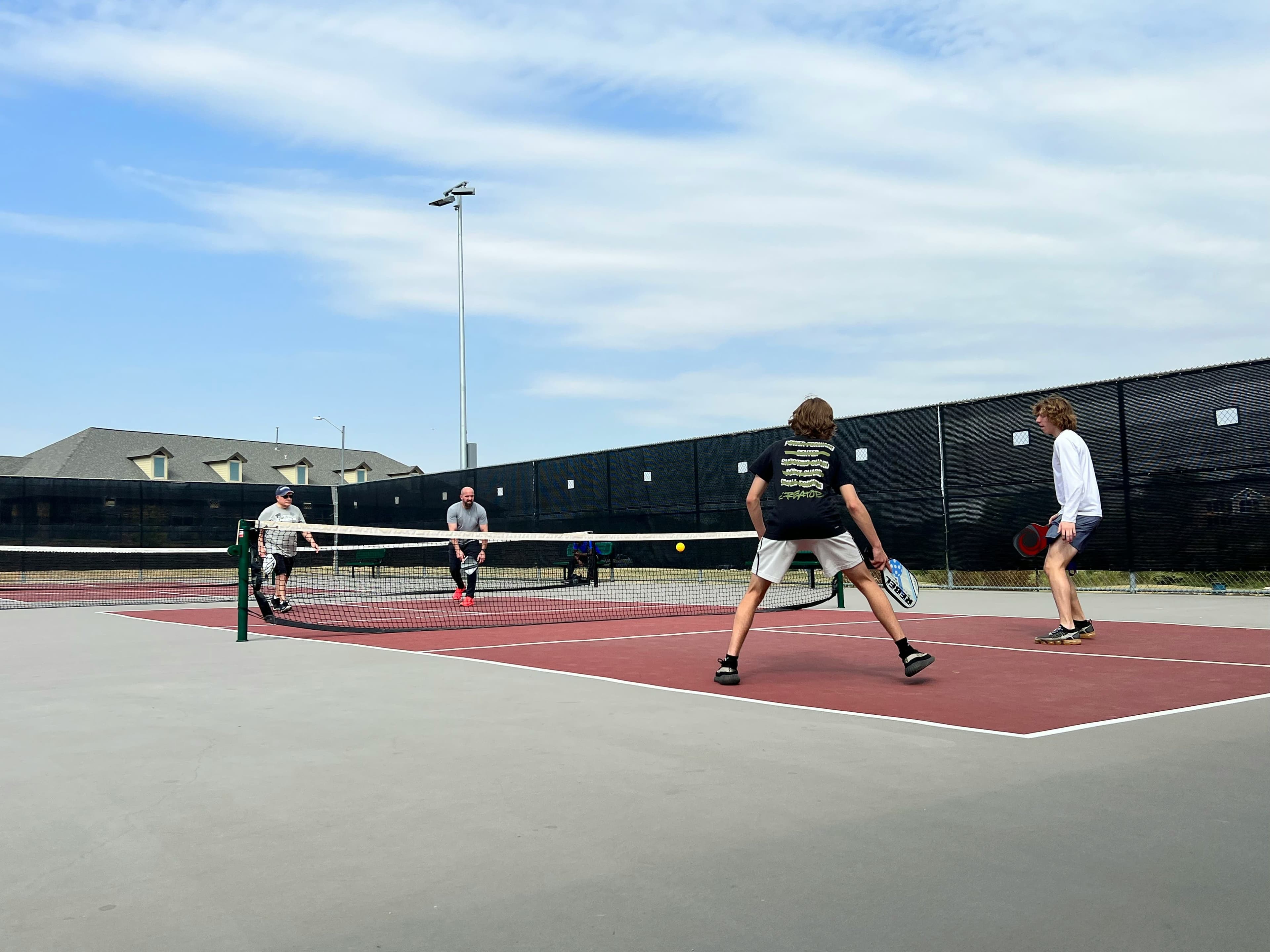 Two Wānaka Pickleball League players competing in a rally on court